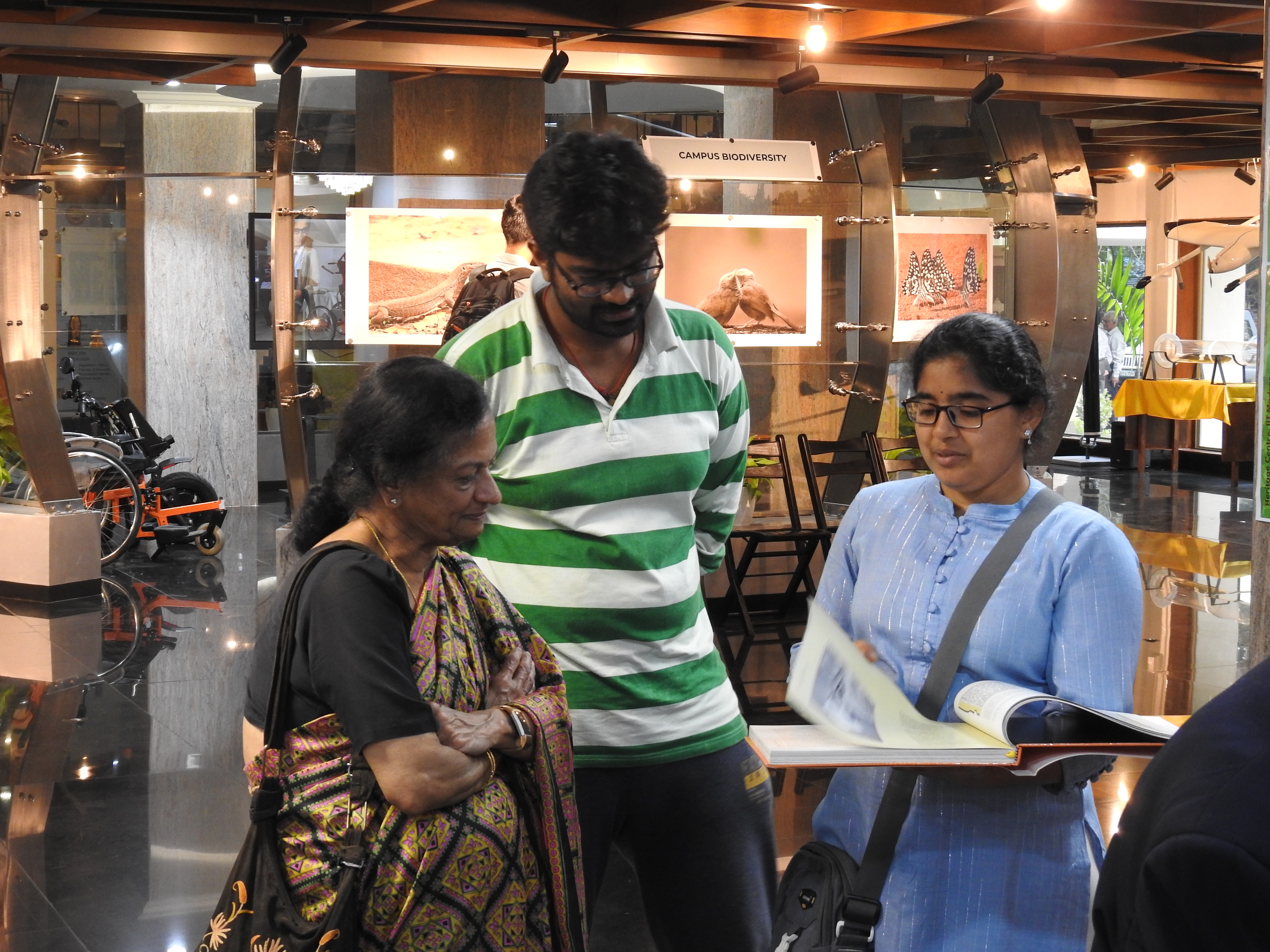 Mrs. Padma and other visitors flip through the Campaschimes coffee table book 