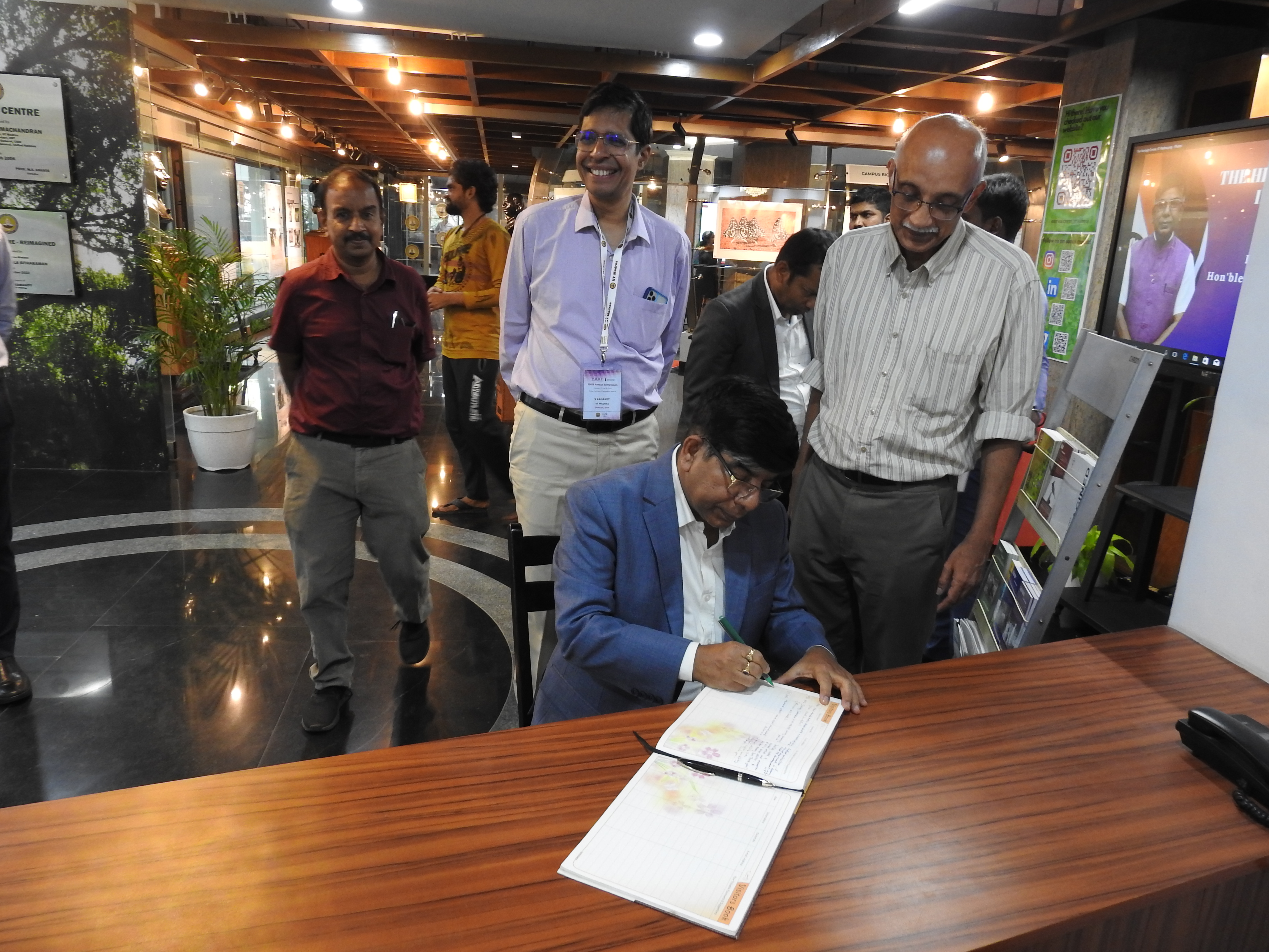 Dr. Subhas Sarkar signs the Visitors' Book at the Heritage Centre as Mr. Kumaran Sathasivam (Operational Manager at Heritage Centre), Prof. V. Kamakoti (Director of IIT Madras) and Prof. R. Nagarajan (Faculty-in-charge of Heritage Centre) look on