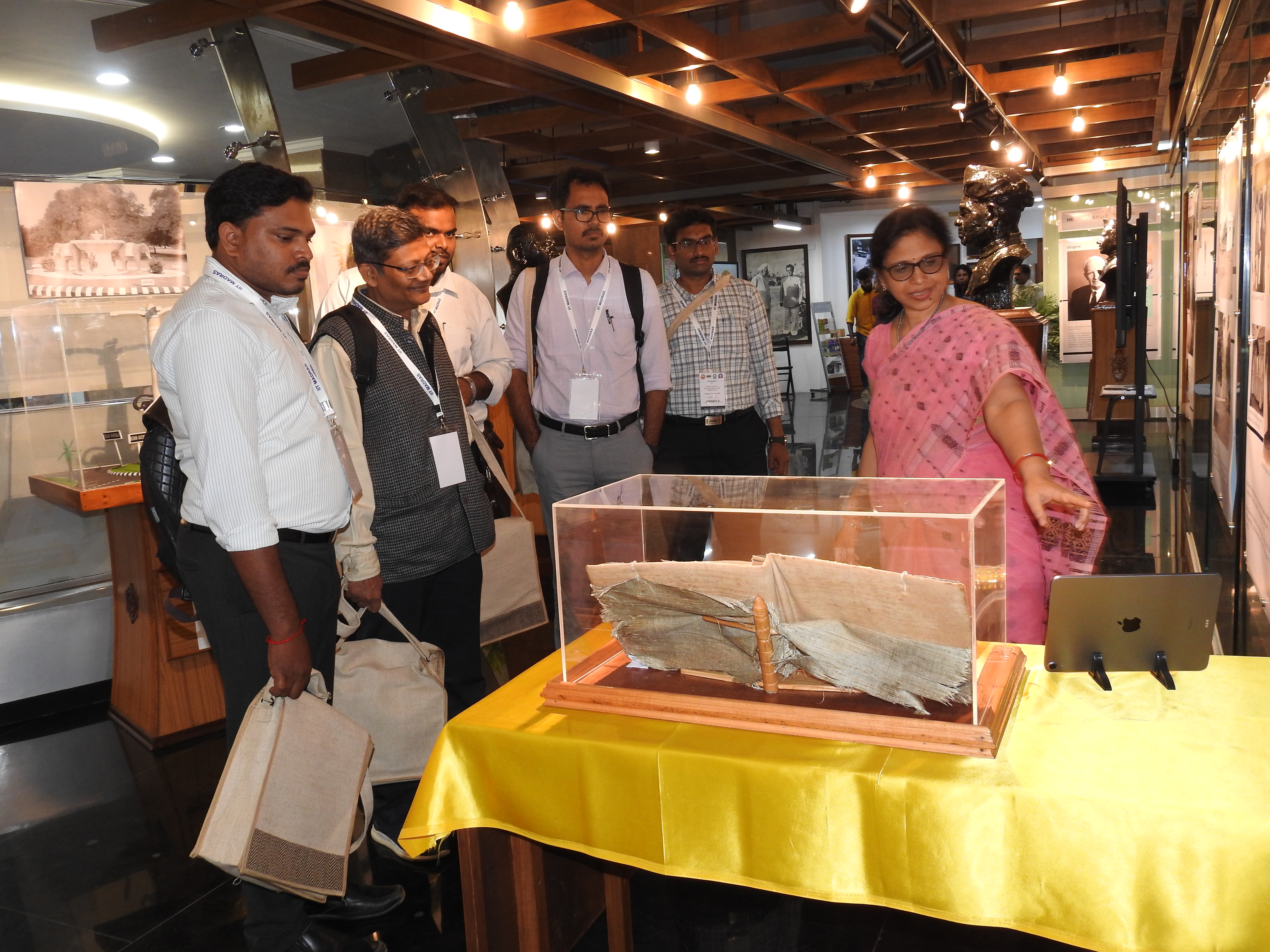 Mrs. Mamata Dash (Senior Project Officer of the Heritage Centre) shows visitors the Visitors' Book, an artefact on display at the Heritage Centre
