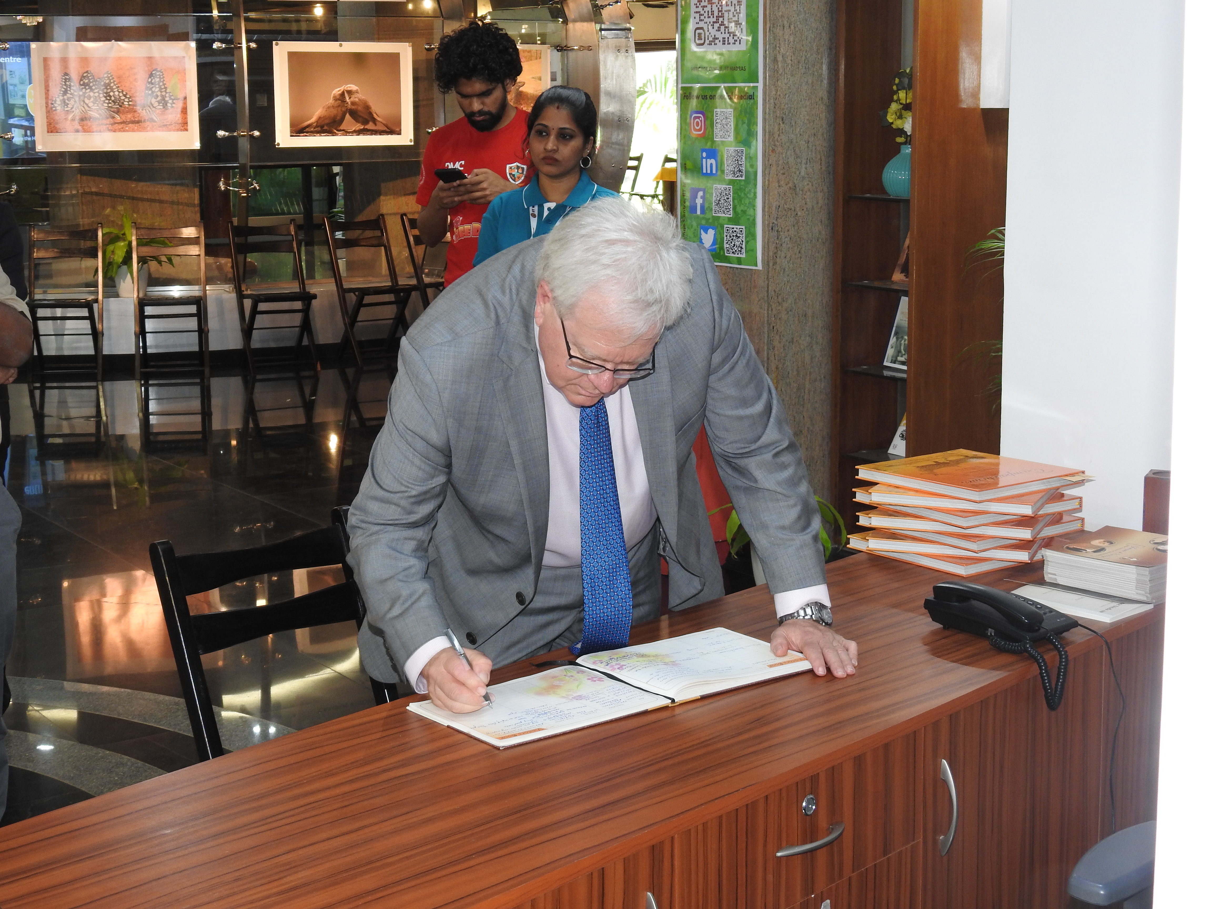 Prof. Schmidt signs in the Visitor's Book