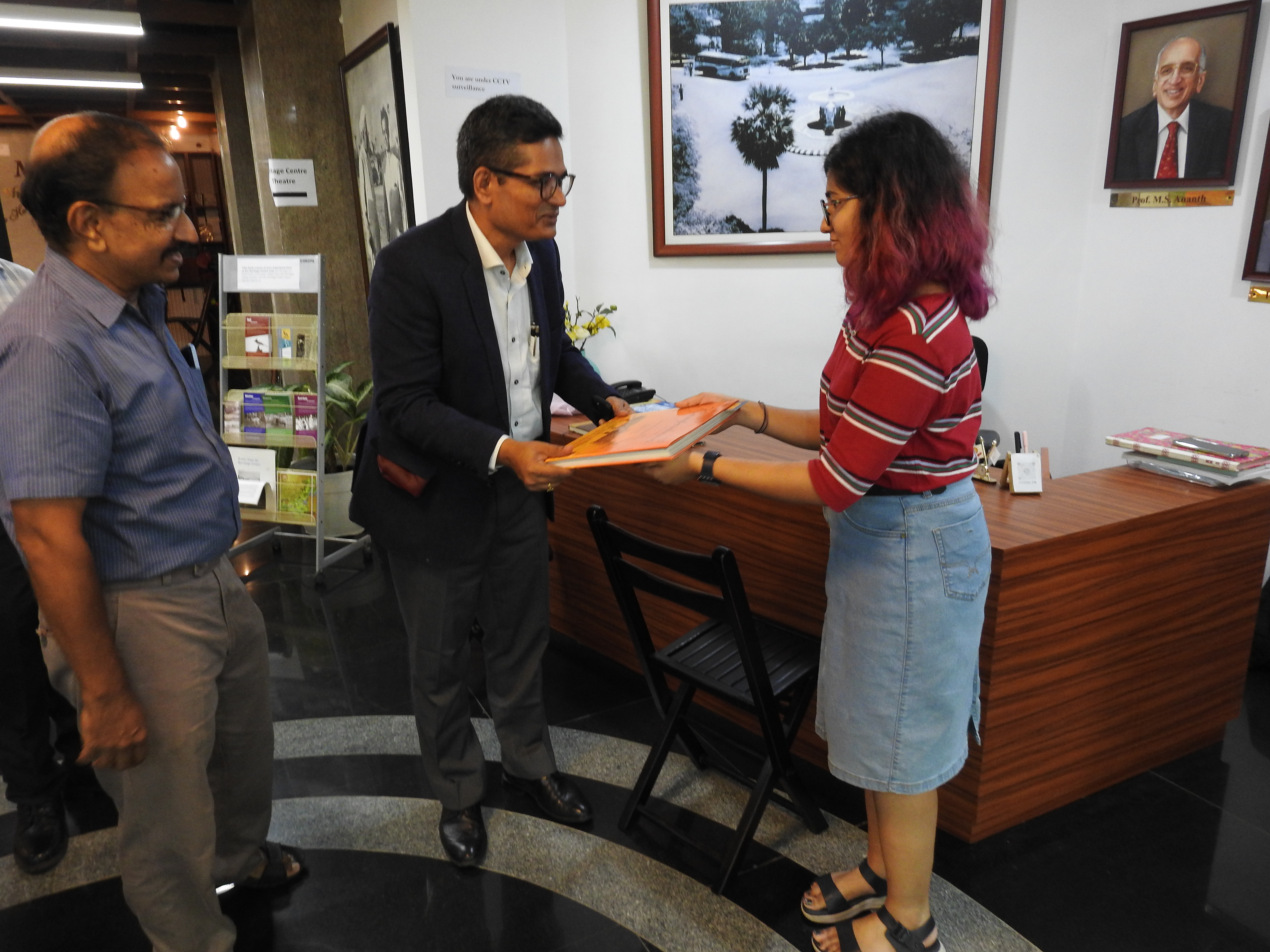 Mr. Krishnakumar Ramanathan receives a copy of Campaschimes from Ms. Ashlin Deena Mathews (Project Associate at the Heritage Centre)