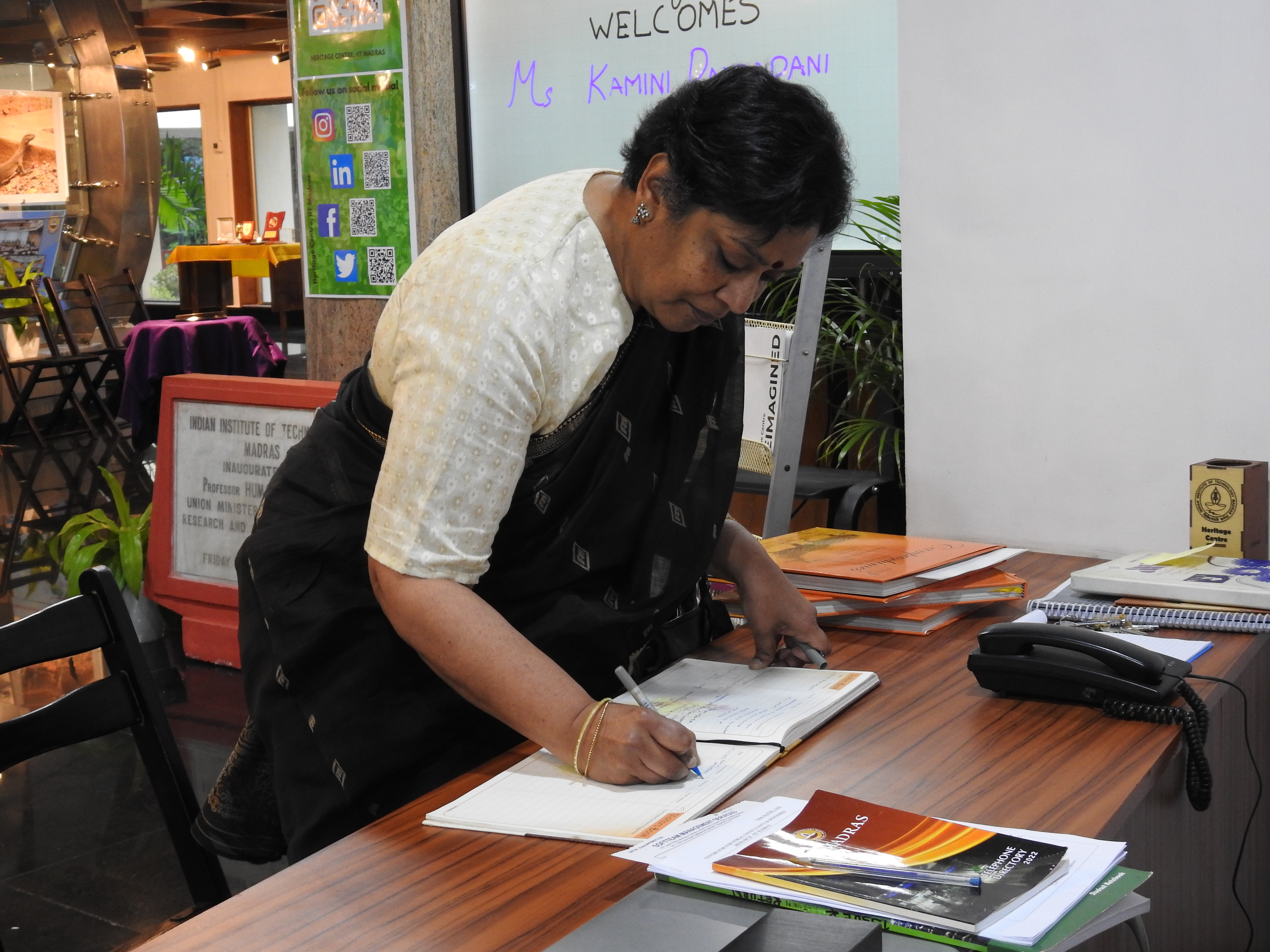 Kamini Dandapani signs the Visitors' Book at the Heritage Centre