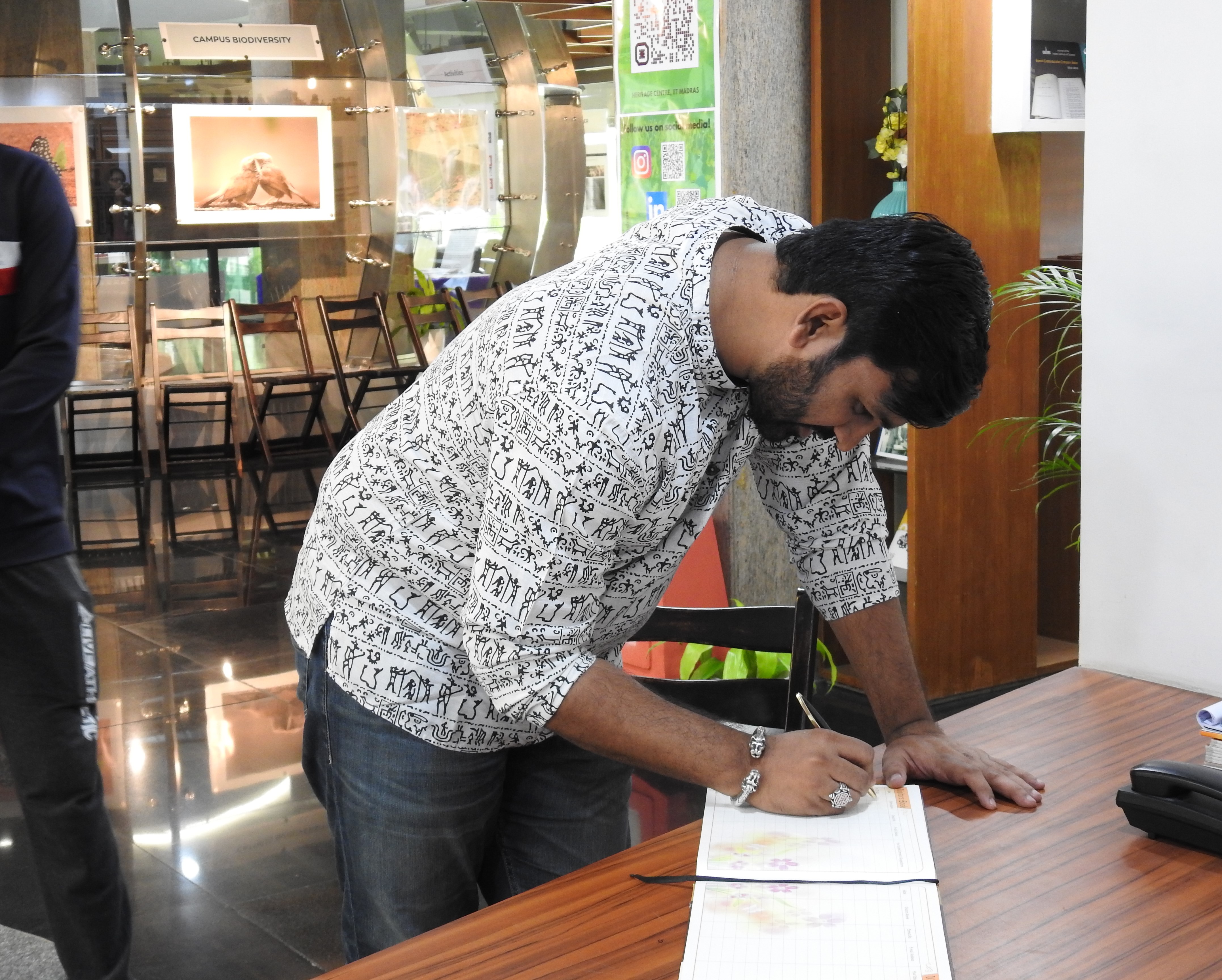 Digpal Lanjekar signs the Visitors' Book