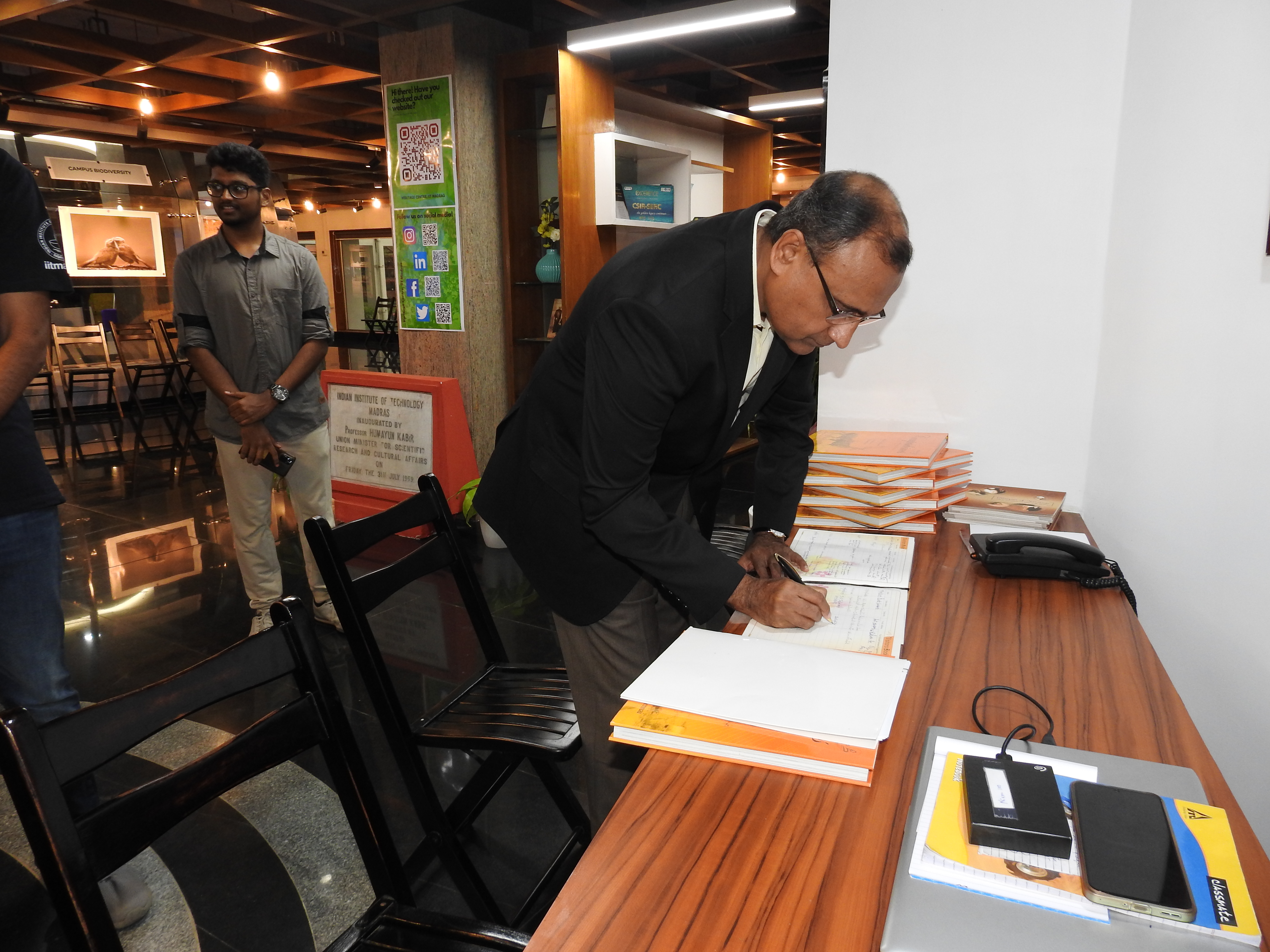 Mr. T. S. Tirumurti signs the Visitors' Book at the Heritage Centre