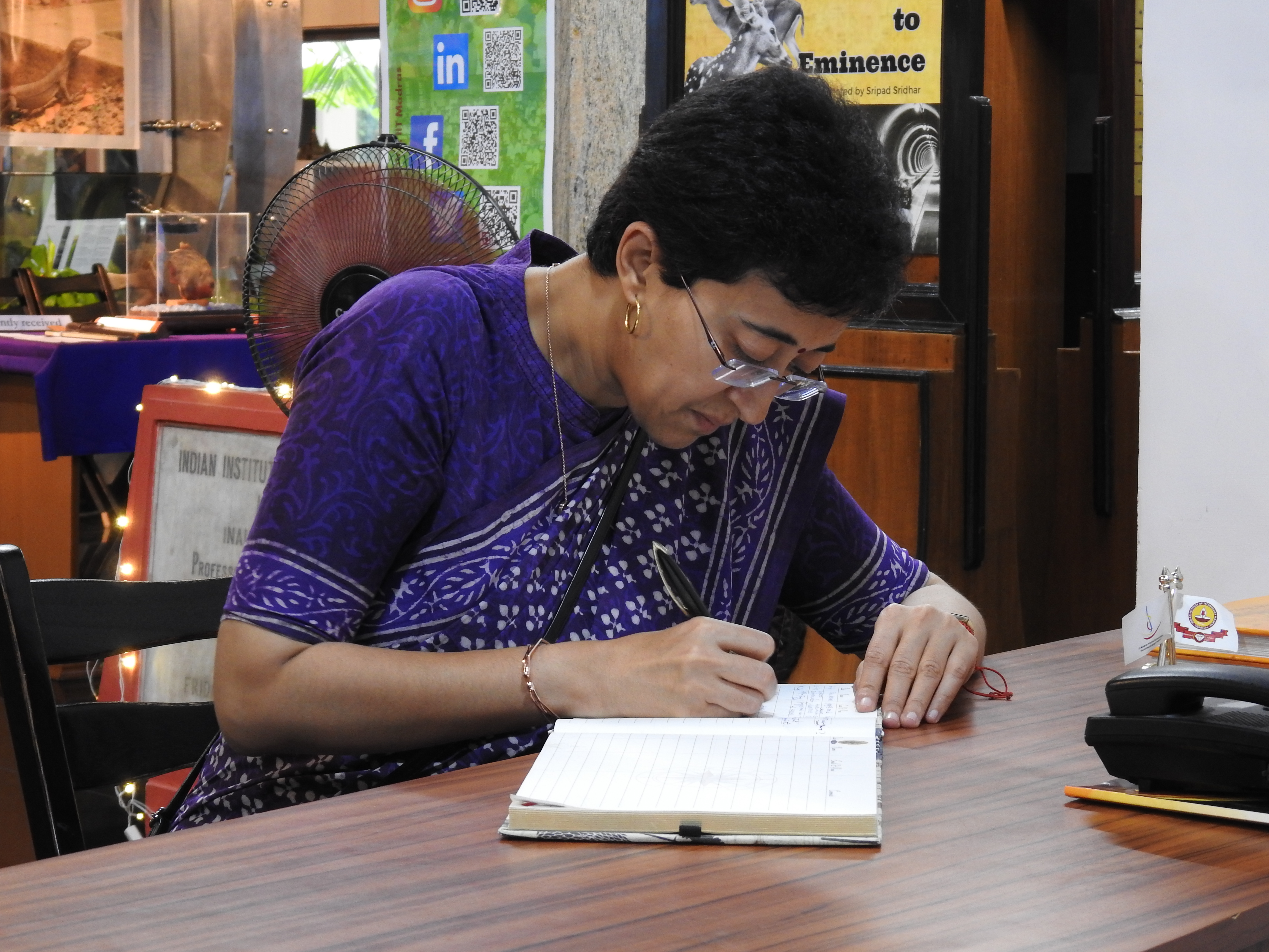 Atishi Marlena signs the visitor's book at the Heritage Centre