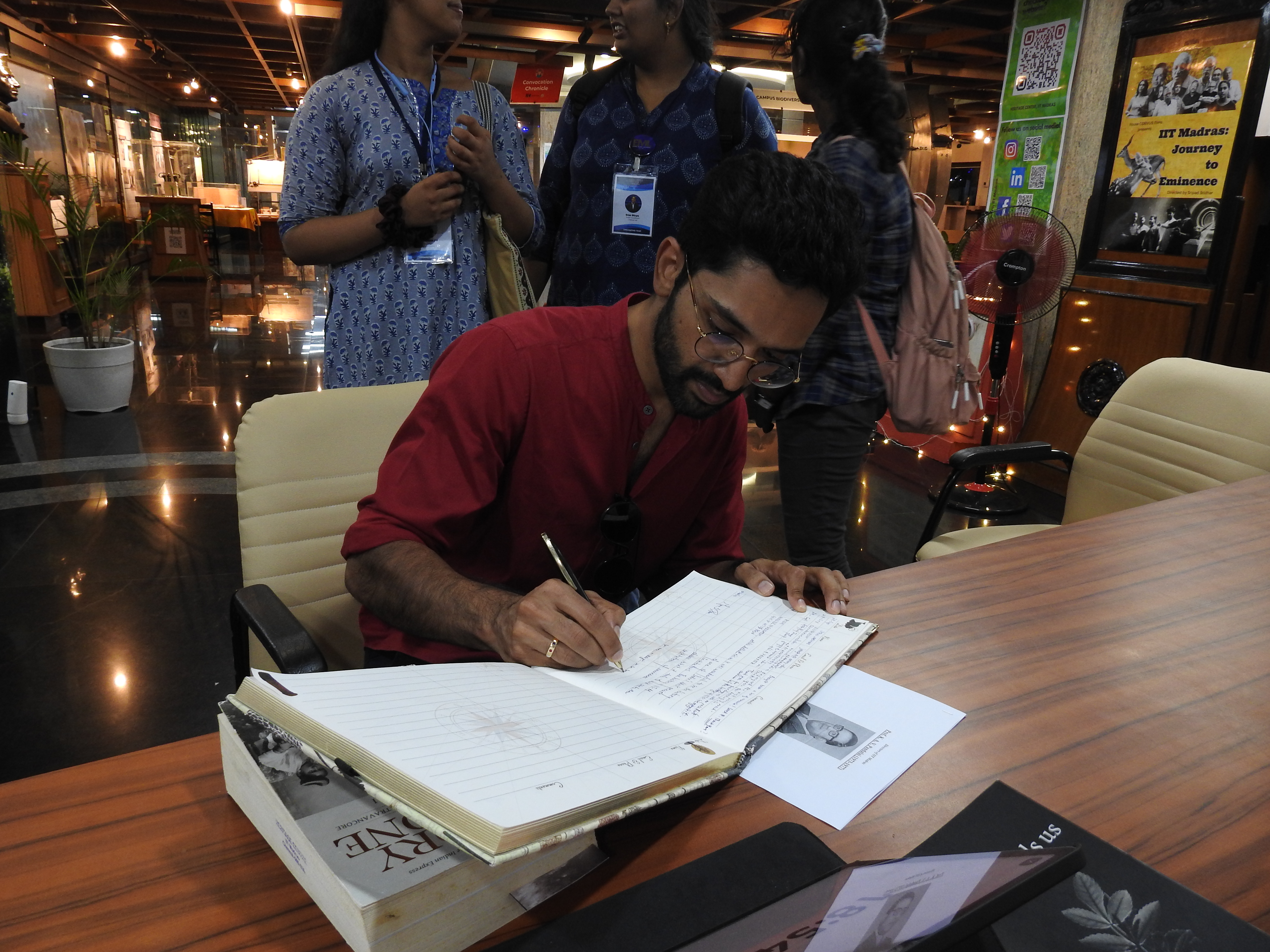 Dr. Manu Pillai signs the visitor's book at the Heritage Centre