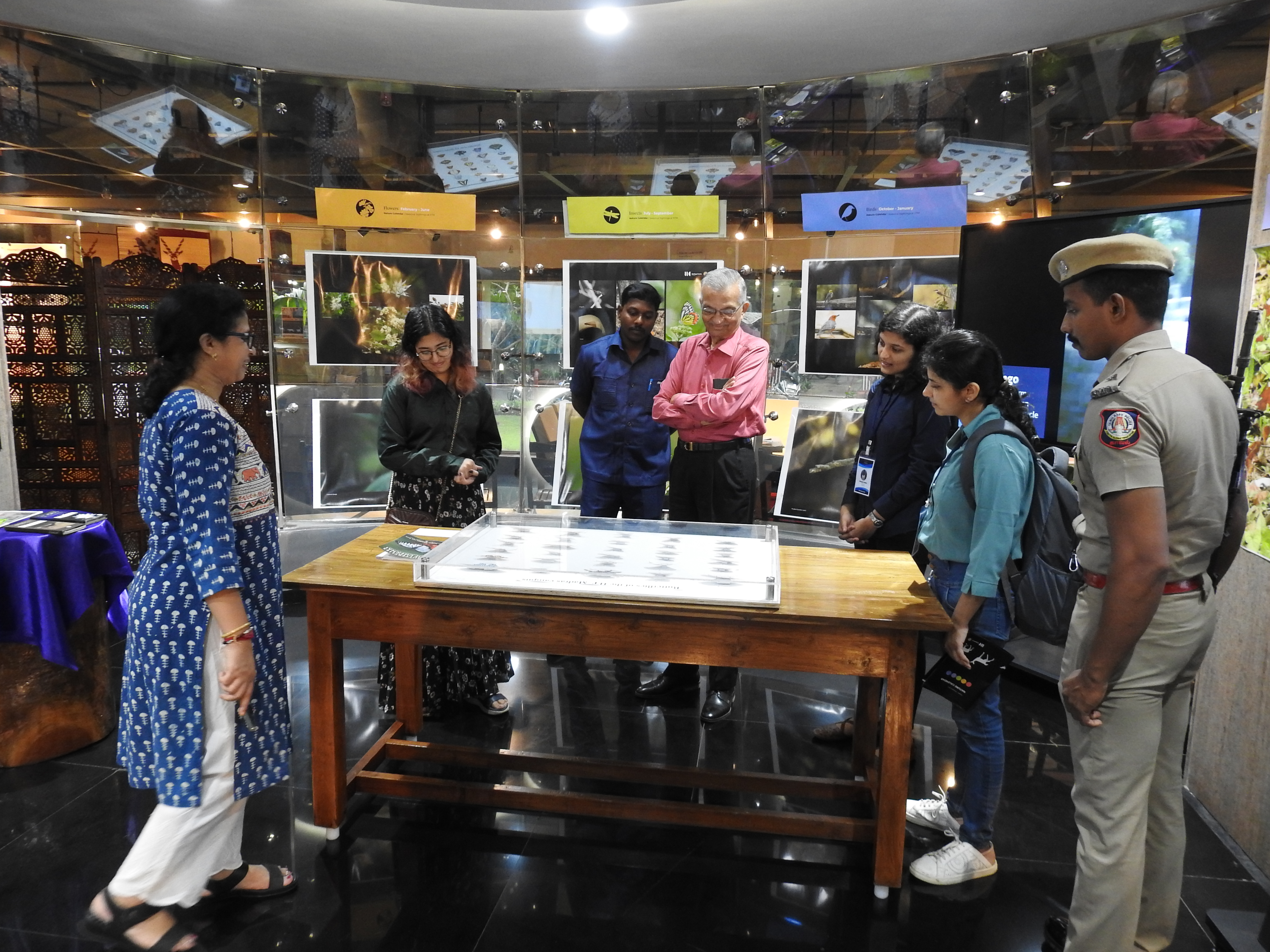 Dr. Kakodkar views the butterfly exhibit of the Nature Calendar exhibition