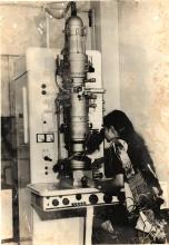 A photograph of a researcher in the Laboratory of Metallurgy at IIT Madras operating a Siemens transmission electron microscope, most likely of the model Elmiskop 1A, taken after 1971