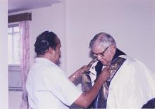 Jamshed J. Irani is assisted in adorning the convocation robes