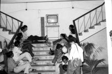 Students by the staircase at Central Lecture Theatre during Mardi Gras (1983) 