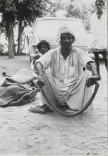 A snake catcher with a cobra