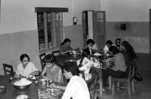 Students and attendees having a meal, possibly at a hostel mess