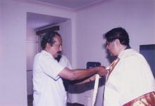 The Director, Prof. R. Natarajan is assisted while adorning the convocation robes