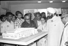 Distinguished guests having a look at the model of the Student Activities Centre building, 1983