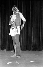 A participant performing on stage in a skit during Mardi Gras (1983)
