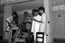 A photograph of students singing a group song during an event at Jamuna Hostel, 1983-84