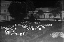 A photograph of students seated inside a hostel possibly during hostel day