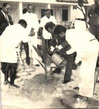 Prof. B. Sengupto waters a newly planted tree at Alakananda Hostel during its inauguration, 1966