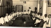 A photograph of faculty members of the Institute gathered at a meeting