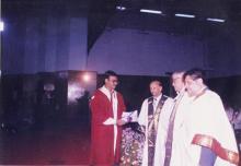 A student receives his award from Mr. Jamshed J. Irani