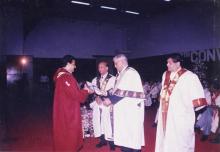 A student receives his award from Mr. Jamshed J. Irani