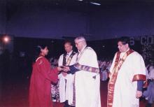 A student receives her award from the chief guest, Mr. Jamshed J. Irani