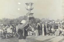 A student hoists a trophy