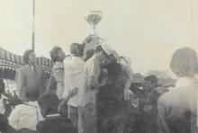 Participants hoist a trophy