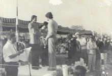 A competition winner receives a medal on the podium 