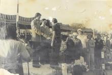 A competition winner is congratulated on the podium