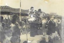 A competition winner is congratulated on the podium