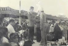 A competition winner is congratulated on the podium