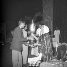 Mrs. Nirmala Medhi presents a trophy to a student during the Fourth Institute Day, 1963