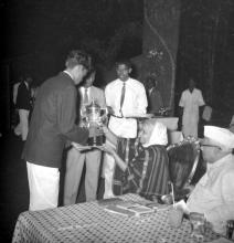Mrs. Nirmala Medhi presents a trophy to a student, 1963
