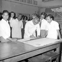 Mr. V. R. Nedunchezhiyan signs the Visitors' book as Prof. G. Rouvé looks on, 1967