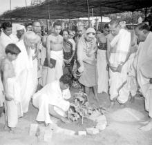 Puduperiyavar waters a sapling outside the Jalakanteshwara Temple, 1965