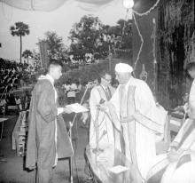 A student receives an award from Sir C. V. Raman
