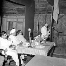 A gentleman addresses the audience, 1961