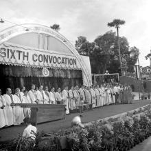 The dignitaries stand for the invocation before the commencement of the convocation ceremony