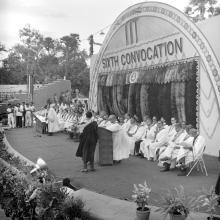 A student walks onto the dais to receive his degree