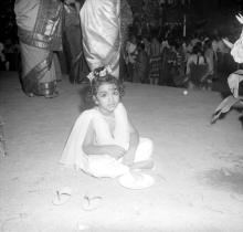 Mr. R. Natarajan's elder daughter, Priya, enjoys the refreshments served at the farewell ceremony organised for her father