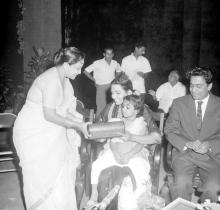 Mrs. Shanti Sengupto presents a gift to Mrs. Parvatham Natarajan at the farewell ceremony organised for Mr. R. Natarajan