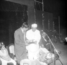 Dr. A. L. Mudaliar presents a memento to Mr. R. Natarajan at the farewell ceremony organised for him