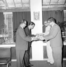 Prof. S. Sampath offers fruits to Prof. B. Sengupto and Mr. C. V. Sethunathan offers fruits to Prof. A. Ramachandran