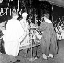 A student receives an award from Dr. S. Radhakrishnan