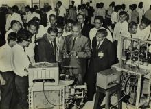 Participants of the Short Term Course in High Vacuum Technology examine a diffusion pump stand with gauges 