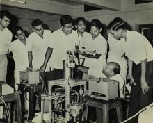 Participants of a short-term course in high-vacuum technology watch a demonstration