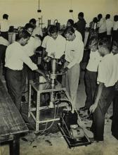 Participants of a short-term course in high-vacuum technology watch a demonstration