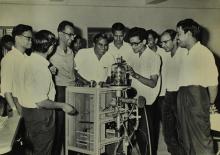 Participants of a short-term course in high-vacuum technology watch a demonstration