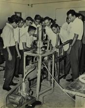 Participants of a short-term course in high-vacuum technology watch a demonstration
